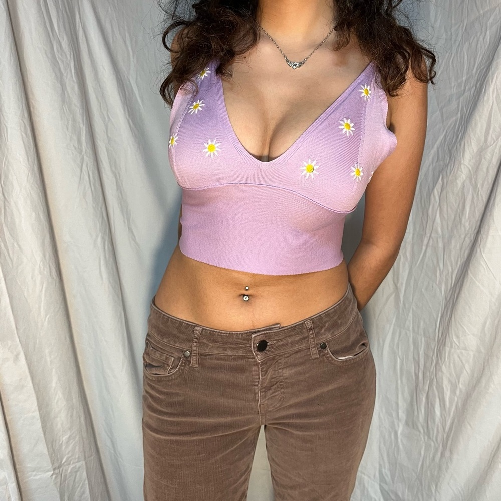 Purple crop top with daisy embroidery.
